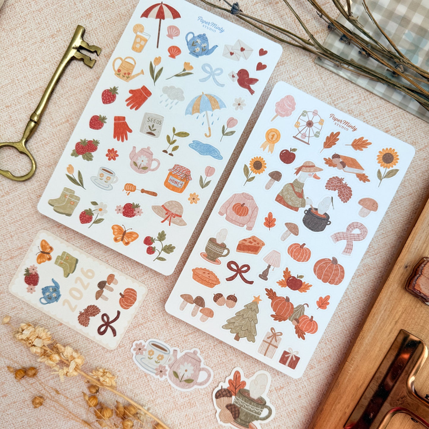 Two sheets of decorative stickers with autumn-themed designs on a textured surface.
