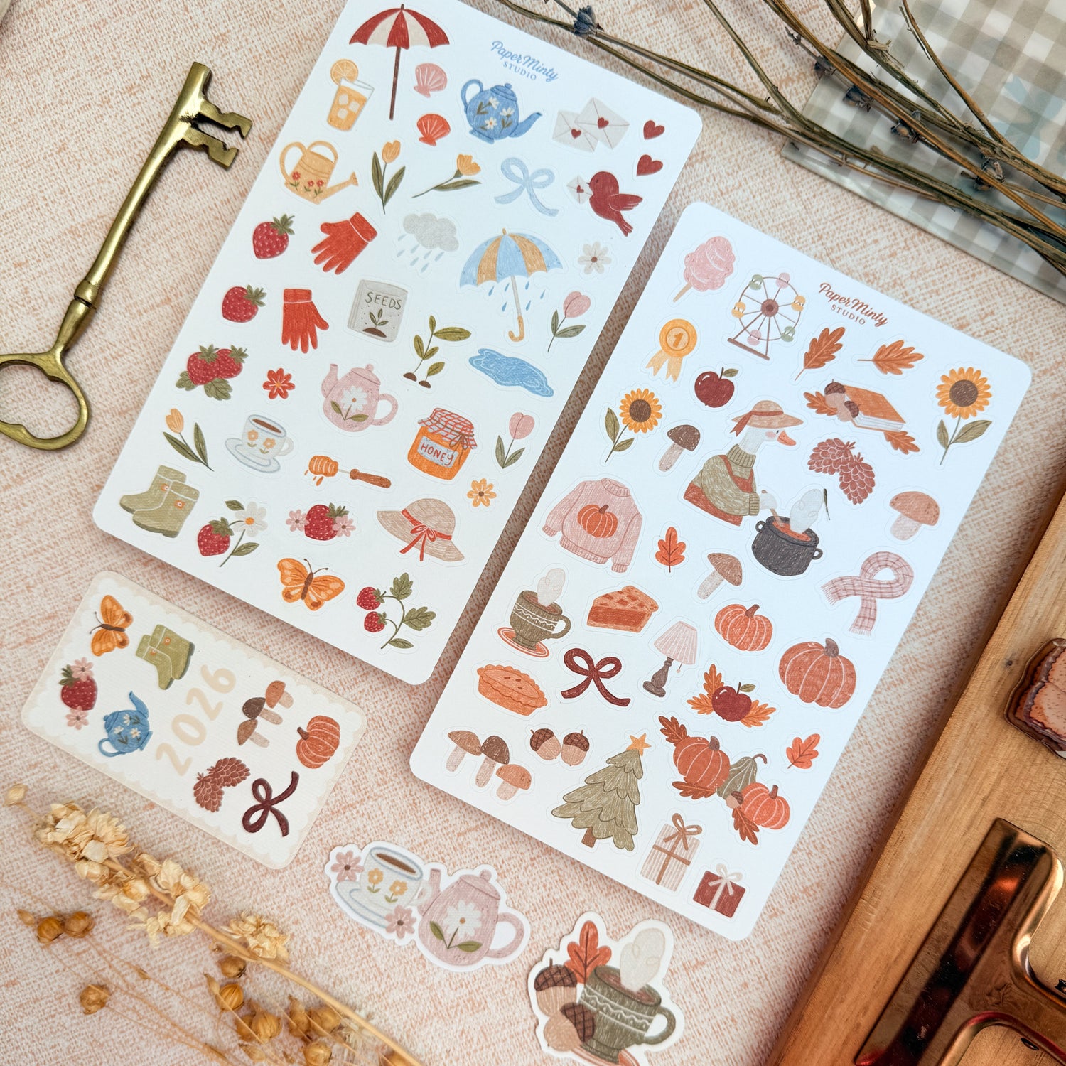 Two sheets of decorative stickers with autumn-themed designs on a textured surface.